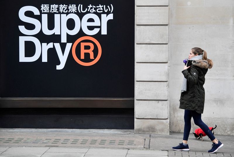 &copy; Reuters. FILE PHOTO: A woman walks past a window display at a Superdry store in London, Britain, March 1, 2019. REUTERS/Toby Melville/File Photo