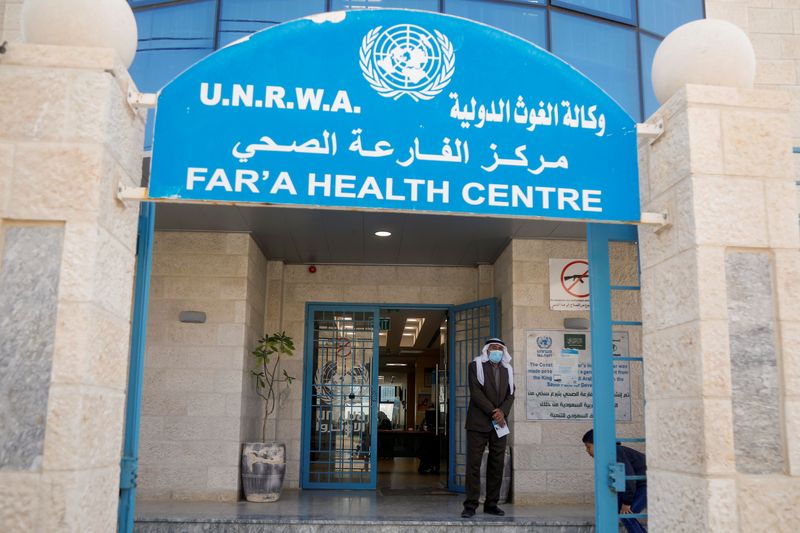 &copy; Reuters. A Palestinian man stands at the entrance of a health center run by the United Nations Relief and Works Agency (UNRWA), at al-Fari'ah refugee camp, in the Israeli-occupied West Bank April 8, 2021. REUTERS/Raneen Sawafta