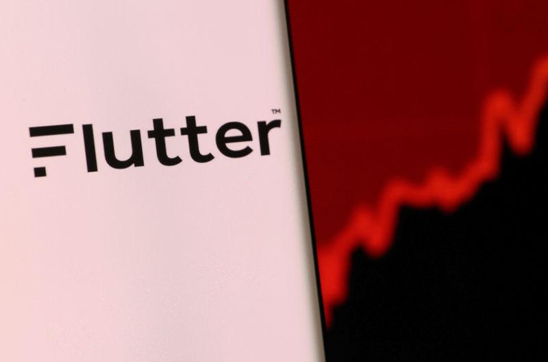 &copy; Reuters. Flutter's logo is pictured on a smartphone in front of the stock graph displayed in this illustration taken, December 4, 2021. REUTERS/Dado Ruvic/Illustration/File Photo