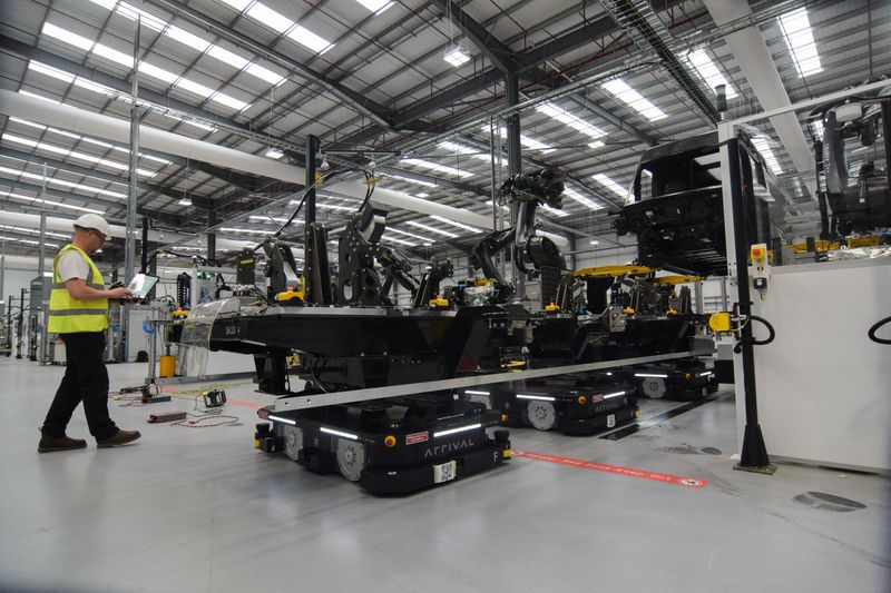 © Reuters. FILE PHOTO: An engineer at electric van maker Arrival watches as autonomous robots move parts for a prototype vehicle at the company's factory in Bicester, Britain, May 10, 2023. REUTERS/Nick Carey/File Photo