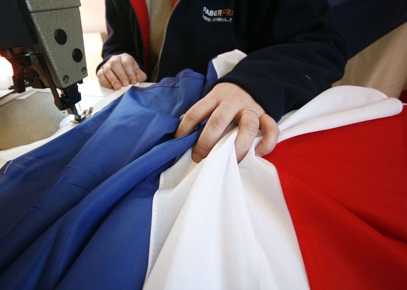 &copy; Reuters. Un operaio cuce una bandiera francese a Wavrin, 5 aprile 2007.  REUTERS/Pascal Rossignol  (FRANCE)