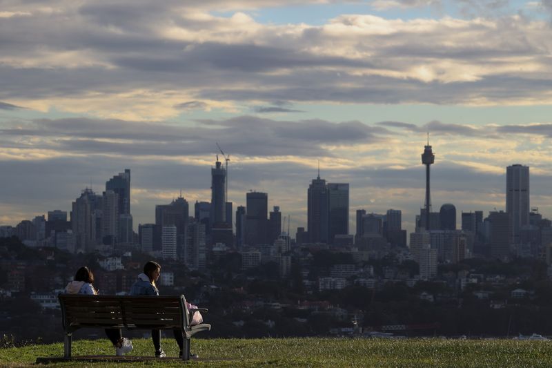 &copy; Reuters. People sit on a bench overlooking the city centre skyline amidst the easing of the restrictions implemented to curb the spread of the coronavirus disease (COVID-19) in Sydney, Australia June 29, 2020.  REUTERS/Loren Elliott/File Photo