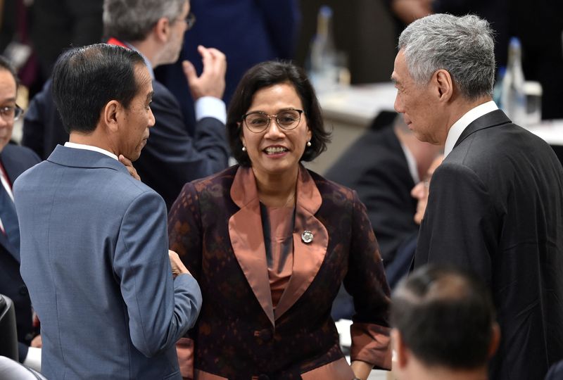 &copy; Reuters. FILE PHOTO: Singapore's Prime Minister Lee Hsien Loong (R) talks with Indonesia's President Joko Widodo (L) and Finance Minister Sri Mulyani Indrawati (C) prior to the session 3 on women's workforce participation, future of work, and ageing societies at t