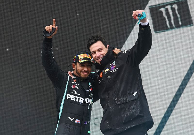 &copy; Reuters. FILE PHOTO: Formula One F1 - Turkish Grand Prix - Istanbul Park, Istanbul, Turkey - November 15, 2020 Mercedes' Lewis Hamilton celebrates on the podium with team principle Toto Wolff after winning the race and the world championship Pool via REUTERS/Ozan 