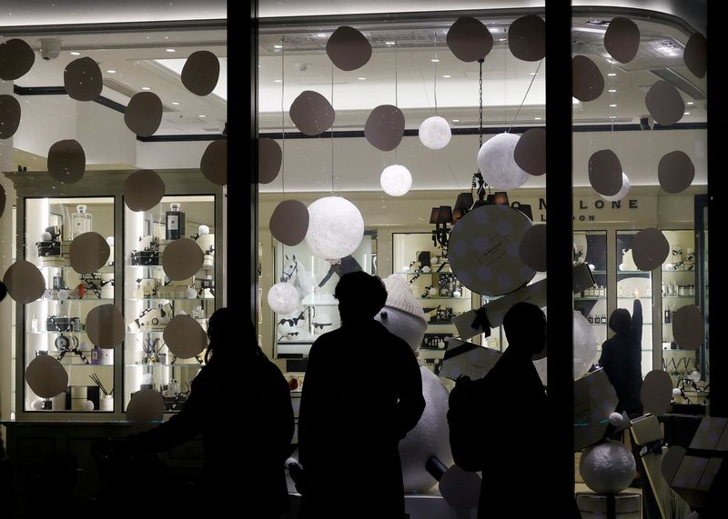 &copy; Reuters. FILE PHOTO: People are silhouetted in front of a show window at a shopping district in Tokyo, Japan December 8, 2022. REUTERS/Kim Kyung-Hoon/File Photo