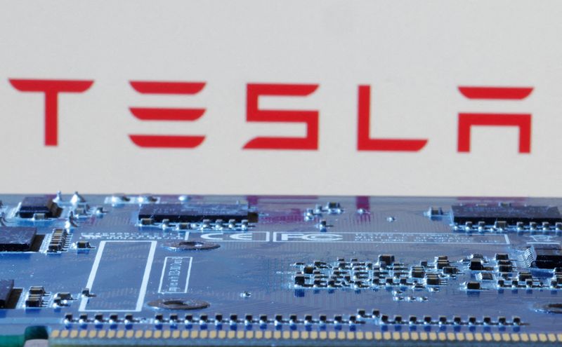 &copy; Reuters. FILE PHOTO: Tesla logo is seen near computer motherboard in this illustration taken January 8, 2024. REUTERS/Dado Ruvic/Illustration/File Photo