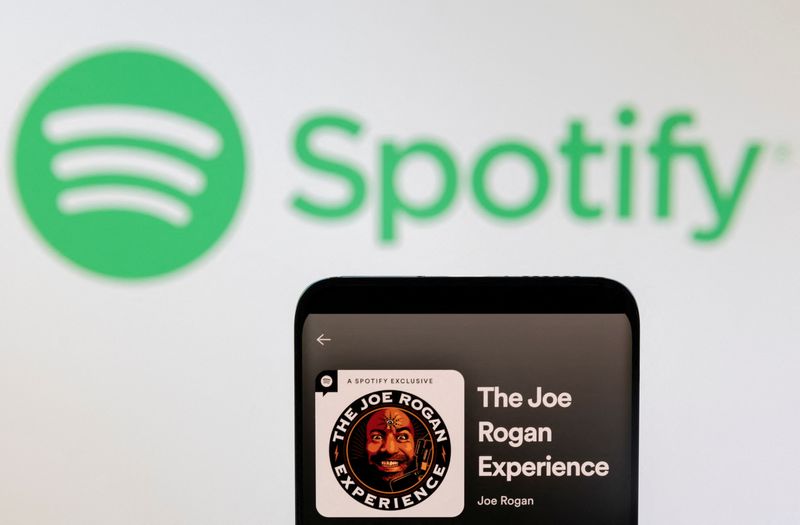 &copy; Reuters. Joe Rogan's Spotify profile is seen in front of displayed Spotify logo in this photo illustration taken, February 7, 2022. REUTERS/Dado Ruvic/Illustration/File Photo
