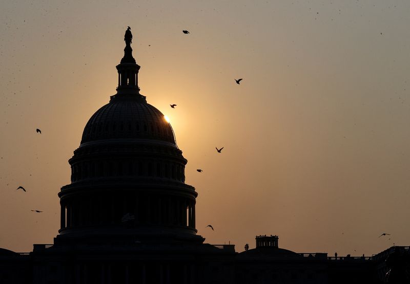 &copy; Reuters. FILE PHOTO: The sun rises behind U.S. Capitol in Washington, U.S., September 13, 2021. REUTERS/Jonathan Ernst/File Photo