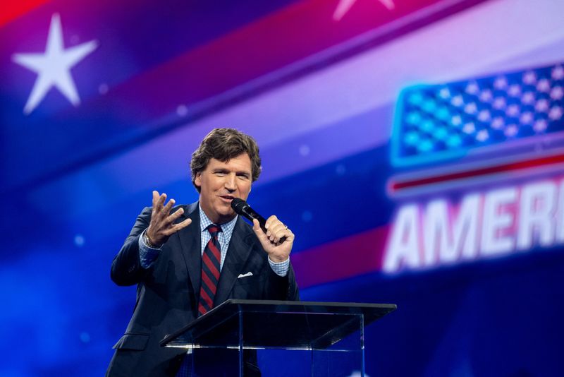 &copy; Reuters. Tucker Carlson speaks as conservative leaders and personalities attend Turning Point USA's AmericaFest 2023 in Phoenix, Arizona, U.S. December 18, 2023.  REUTERS/Caitlin O’Hara/File Photo