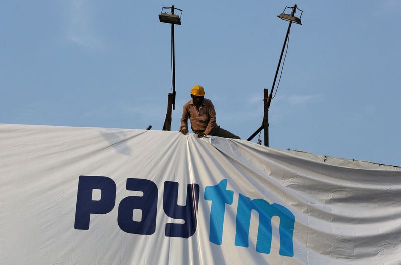 &copy; Reuters. FILE PHOTO: A worker adjusts a hoarding of Paytm, a digital payments firm, in Ahmedabad, India, January 31, 2019. Picture taken January 31, 2019. REUTERS/Amit Dave/File Photo