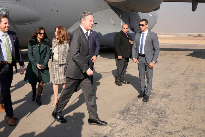 &copy; Reuters. U.S. Secretary of State Antony Blinken walks after being welcomed by U.S. Ambassador to Egypt Herro Mustafa Garg and Sarah Henry, Second Secretary at the Protocol Department of Egyptian Ministry of Foreign Affairs protocol, upon his arrival at Cairo Airpo