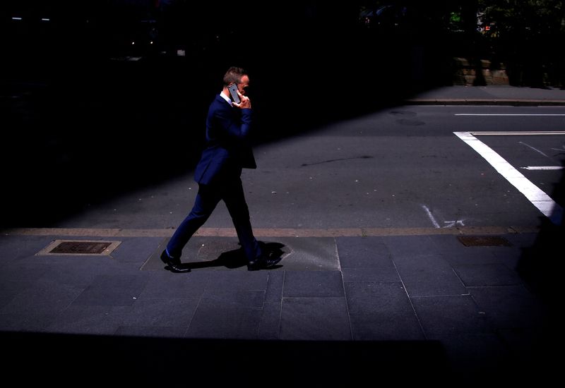 &copy; Reuters. FILE PHOTO: A businessman talks on his Apple iPhone as he walks along a street in the central business district (CBD) of Sydney in Australia, October 24, 2017. REUTERS/David Gray/File Photo