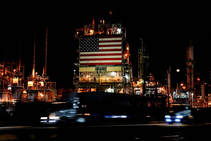 &copy; Reuters. FILE PHOTO: Semi trucks drive past a giant U.S. flag displayed at Marathon Petroleum's Los Angeles Refinery in Carson, California, U.S., March 11, 2022. Picture taken March 11, 2022. Picture taken with long exposure. REUTERS/Bing Guan/File Photo