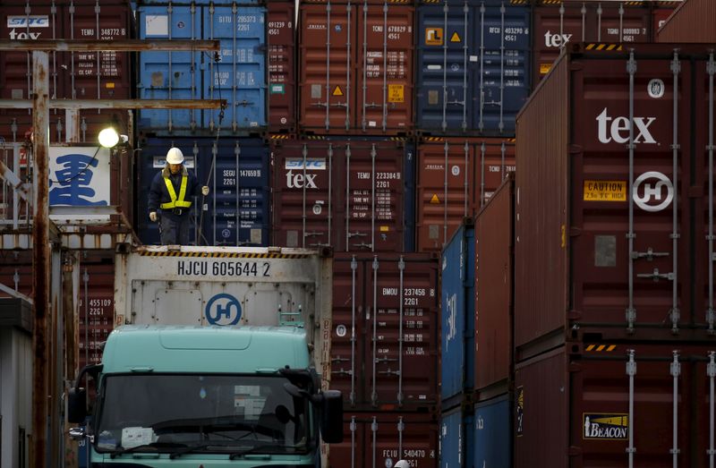 &copy; Reuters. FILE PHOTO: A laborer works in a container area at a port in Tokyo, Japan, March 16, 2016. REUTERS/Toru Hanai/File Photo