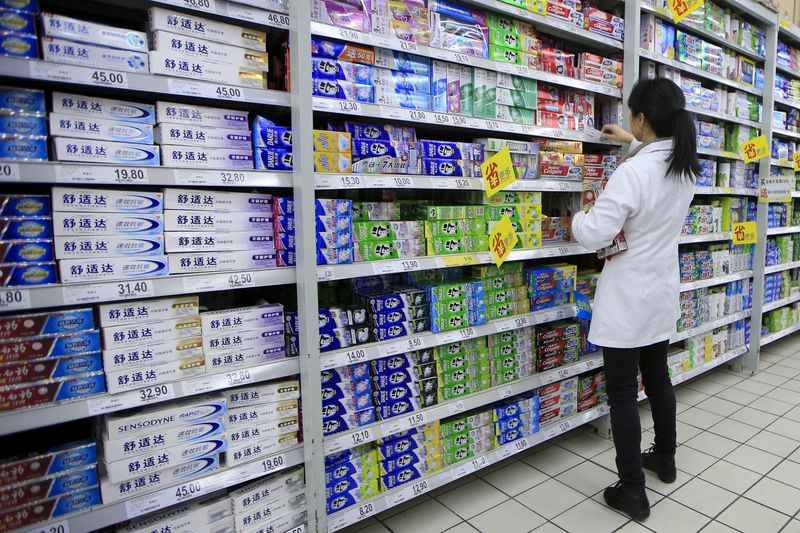 &copy; Reuters. FILE PHOTO: A salesperson arranges toothpaste products on a shelf at a supermarket in Shanghai, China, March 10, 2016. REUTERS/Aly Song/File Photo