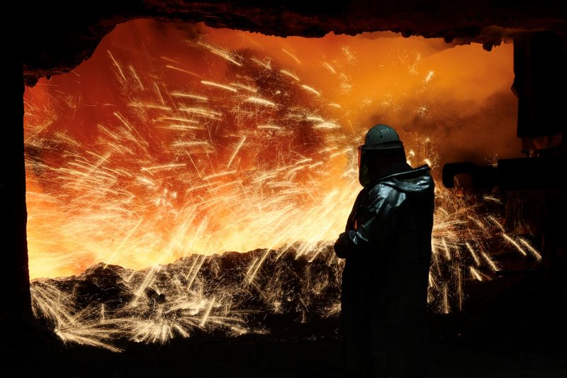 &copy; Reuters. A steel worker in heat protection gear is silhouetted against the sparkling fire of Europe's largest furnace with a daily raw iron production of 12,000 tons, at the steel plant of ThyssenKrupp in Duisburg, Germany, November 16, 2023.  REUTERS/Wolfgang Rat