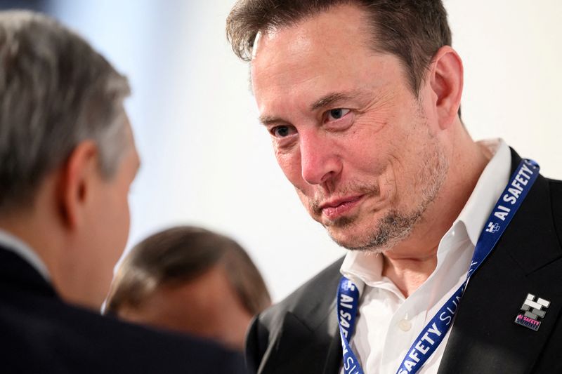 &copy; Reuters. FILE PHOTO: Tesla, X (formerly known as Twitter) and SpaceX's CEO Elon Musk speaks with other delegates on Day 1 of the AI Safety Summit at Bletchley Park in Bletchley, Britain on November 1, 2023. Leon Neal/Pool via REUTERS/File Photo