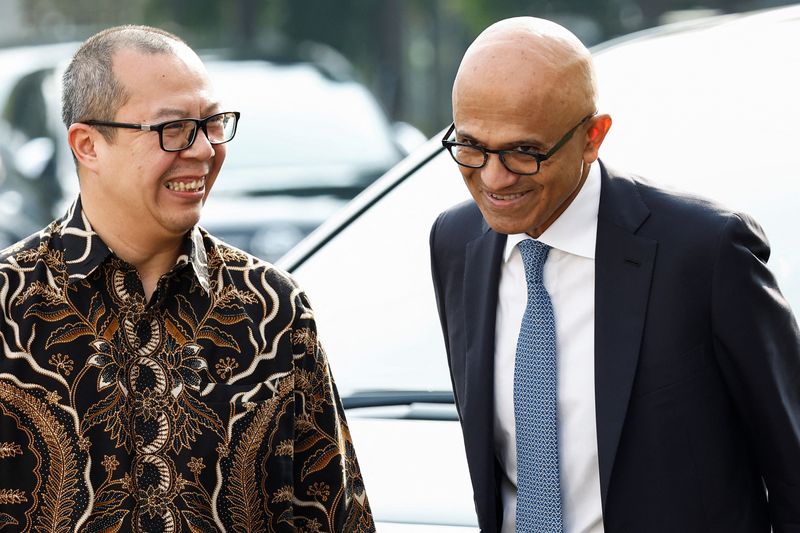 &copy; Reuters. Satya Nadella, Executive Chairman and CEO of Microsoft Corporation reacts with Lucky Gani, Chief Operating Officer (COO) of Microsoft Indonesia, upon their arrival at the Presidential Palace as they were scheduled to meet Indonesian President Joko WIdodo,