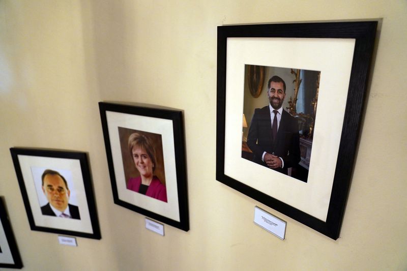 &copy; Reuters. Photos of Scotland's First Minister are displayed on a wall in Bute House, the official residence, where Scotland's First Minister Humza Yousaf said he will resign as SNP leader and Scotland's First Minister, avoiding having to face a no-confidence vote i