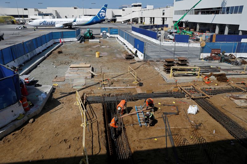 &copy; Reuters. FILE PHOTO: Workers prepare a cabling trench at a construction site at Los Angeles International Airport (LAX) in Los Angeles, California, U.S., March 30, 2022. Picture taken March 30, 2022.  REUTERS/Chris Helgren/File Photo