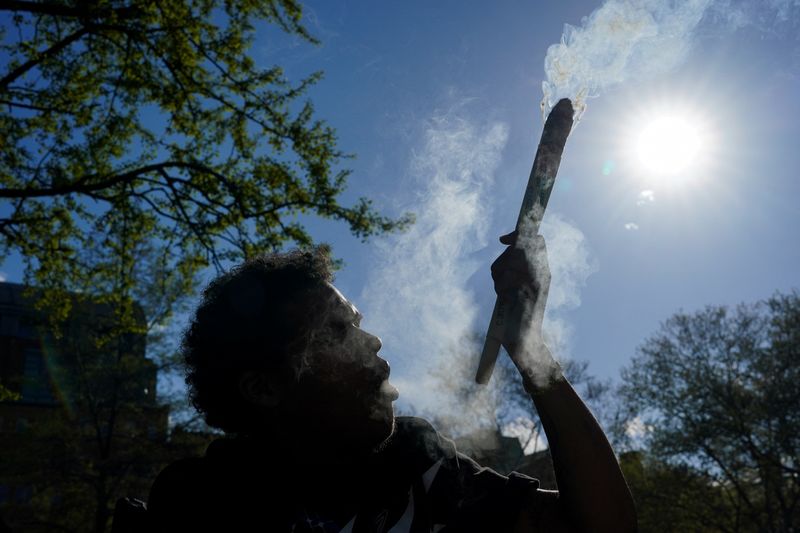 &copy; Reuters. FILE PHOTO: An enthusiast marks the informal annual cannabis holiday, 4/20 (four-twenty), corresponding to the numerical figure widely recognized within the cannabis subculture as a symbol for all things related to marijuana, at Washington Square Park in 