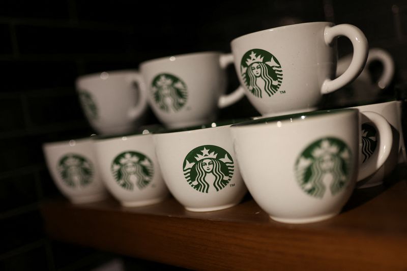 &copy; Reuters. FILE PHOTO: Branded coffee mugs are displayed in Starbucks' outlet at a market in New Delhi, India, May 30, 2023. REUTERS/Anushree Fadnavis
