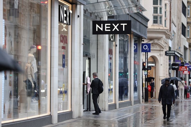 &copy; Reuters. FILE PHOTO: A shopper enters a Next store on Oxford Street in London, Britain, July 31, 2023. REUTERS/Hollie Adams/File Photo