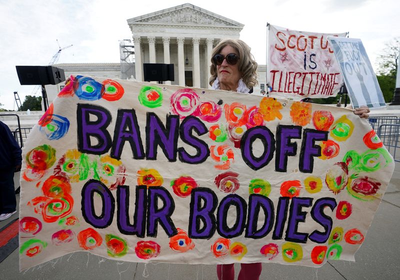 &copy; Reuters. FILE PHOTO: An abortion rights supporter holds a banner on the day the Supreme Court justices hear oral arguments over the legality of Idaho's Republican-backed, near-total abortion ban in medical-emergency situations, at the U.S. Supreme Court in Washing