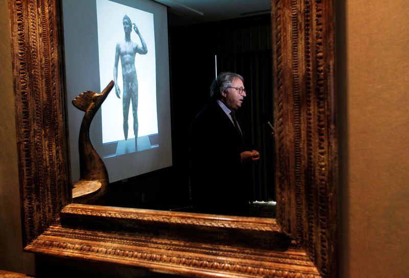 &copy; Reuters. FILE PHOTO: Gian Mario Spacca, then president of the Italian region of Marche, is seen reflected in a mirror while being interviewed after speaking about the ongoing dispute with J. Paul Getty Museum relating to the statue "Victorious Youth," also known a