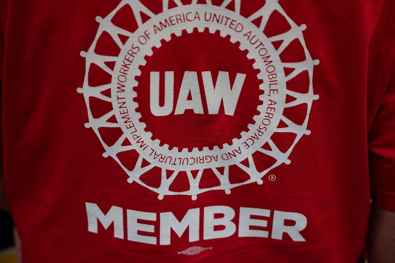 &copy; Reuters. FILE PHOTO: A person wearing a T-shirt that has "UAW member" written on it is pictured as the result of a vote comes in favour of the hourly factory workers at Volkswagen's assembly plant to join the United Auto Workers (UAW) union, during a watch party i