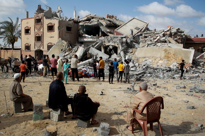 &copy; Reuters. Varios palestinos miran un edificio destruido por un ataque israelí en Rafah, en el sur de la Franja de Gaza. 5 mayo 2024. REUTERS/Hatem Khaled