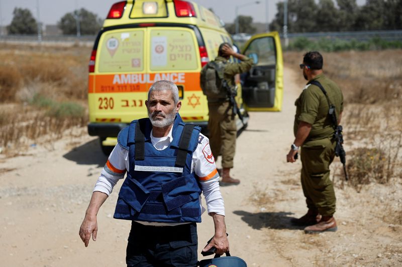 &copy; Reuters. Un médico camina junto a varios soldados israelíes cerca de una ambulancia después de que el grupo islamista Hamás se atribuyó un ataque mortal contra el cruce de Kerem Shalom, en la frontera de Israel con la Franja de Gaza. 5 mayo 2024. REUTERS/Amir
