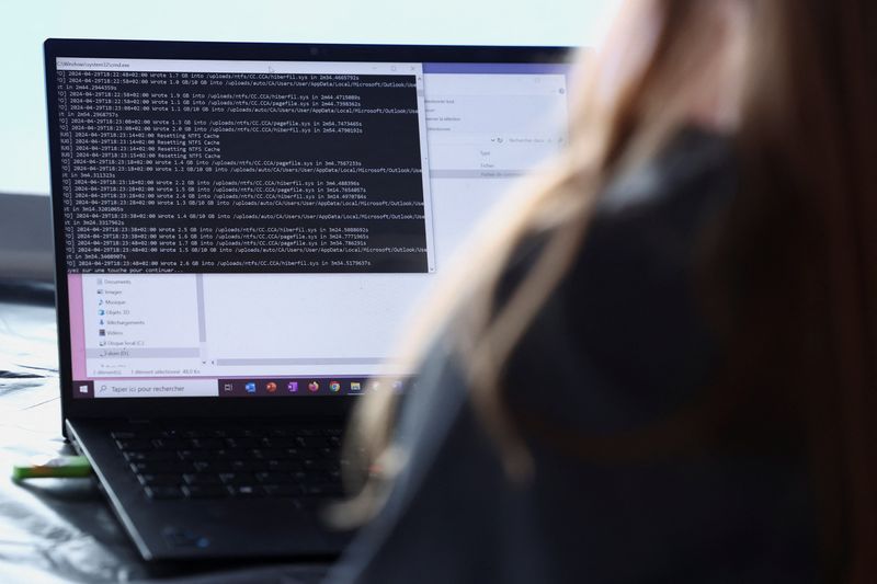 &copy; Reuters. A cybersecurity employee from the Paris 2024 flying squad manages a simulated cyber attack and pretends to resolve it from a computer on the Olympic site which will host the hockey events at Yves-du-Manoir Stadium in Colombes, near Paris, France, May 3, 2
