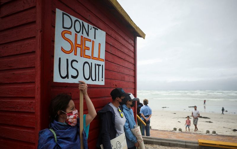 &copy; Reuters. FILE PHOTO: A protestor holds a placard as she joins a demonstration against oil major Royal Dutch Shell's plans to start seismic surveys to explore petroleum systems off the country's popular Wild Coast, at Muizenberg beach in Cape Town, South Africa, De