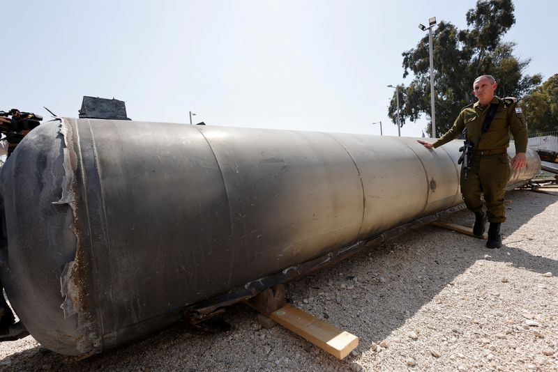 &copy; Reuters. المتحدث باسم الجيش الإسرائيلي دانيال هاجاري يقف إلى جانب ما قال الجيش الإسرائيلي إنه صاروخ باليستي إيراني انتشله من البحر الميت بعدما أطلق