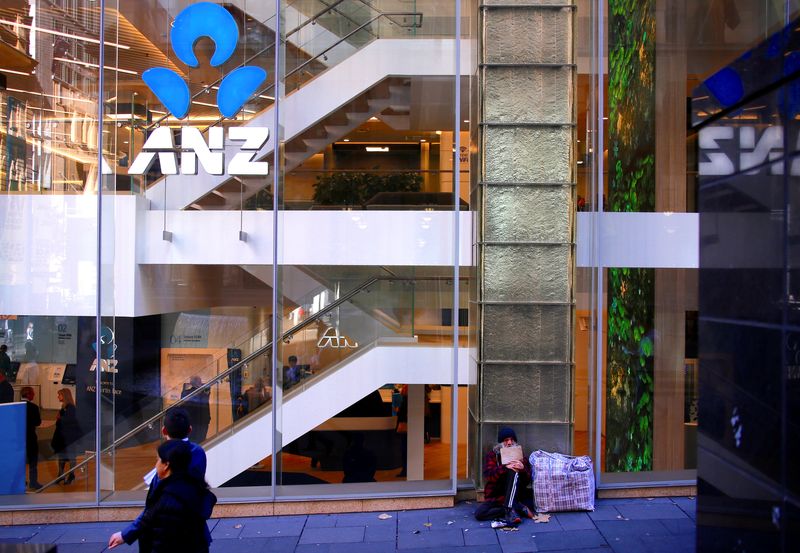 &copy; Reuters. FILE PHOTO: A man who says he is been homeless for over 30 years begs for money as he sits outside a branch of the ANZ Banking Group in central Sydney, Australia, July 18, 2017. REUTERS/David Gray/File photo