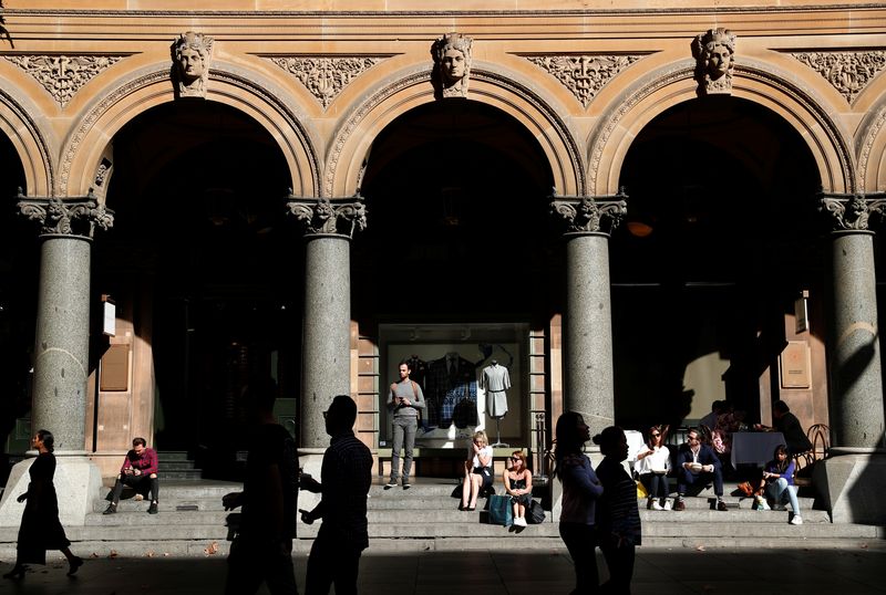 &copy; Reuters. FILE PHOTO: Office workers walk past the General Post Office building during lunchtime in Sydney, Australia May 4, 2018. REUTERS/Edgar Su/File photo