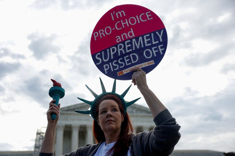 &copy; Reuters. FILE PHOTO: Laurie Woodward Garcia from Tampa, Florida, holds a placard during a "die-in" protest in support of reproductive rights and emergency abortion care, as Supreme Court justices hear oral arguments over the legality of Idaho's Republican-backed, 