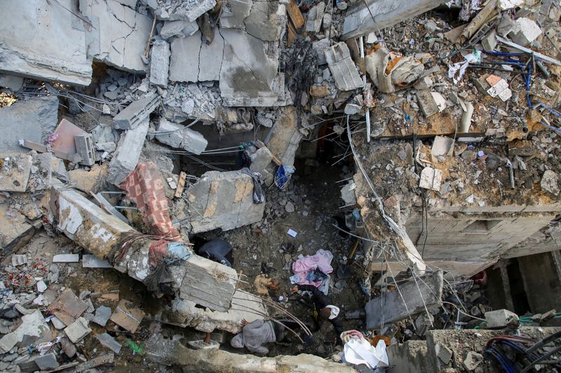&copy; Reuters. Palestinos inspeccionando el lugar de un ataque israelí contra una casa, en medio del actual conflicto entre Israel y el grupo islamista palestino Hamás, en Ráfah, sur de la Franja de Gaza. 7 de mayo de 2024. REUTERS/Hatem Khaled