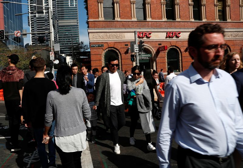 &copy; Reuters. People cross a street in Sydney, Australia May 8, 2018. REUTERS/Edgar Su/File Photo