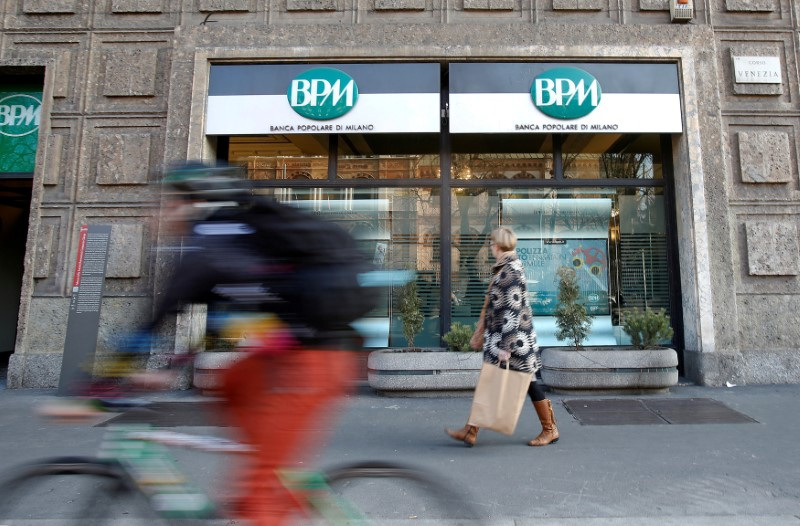 &copy; Reuters. FILE PHOTO: A woman walks in front of the Banca Popolare di Milano (BPM) bank in downtown Milan, Italy, January 29, 2016.   REUTERS/Alessandro Garofalo/File Photo