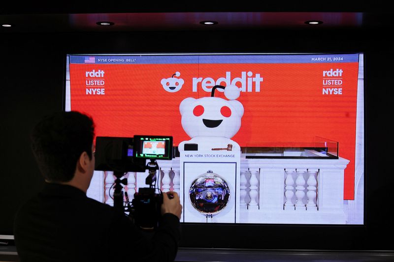 &copy; Reuters. FILE PHOTO: A person records the Reddit mascot as it rings the opening bell, at the New York Stock Exchange (NYSE) in New York City, U.S., March 21, 2024. REUTERS/Brendan McDermid/File Photo