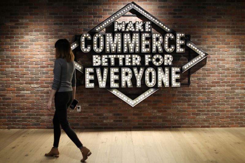 &copy; Reuters. An employee walks past a sign at Shopify's headquarters in Ottawa, Ontario, Canada, October 22, 2018. REUTERS/Chris Wattie/File Photo