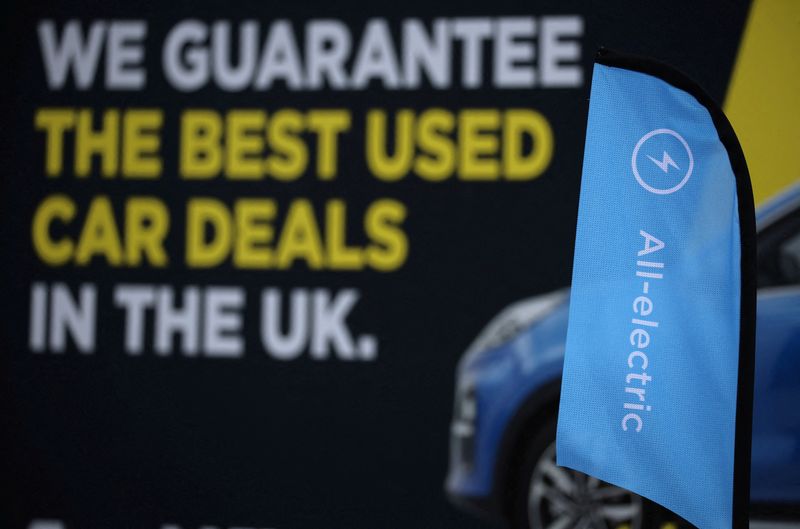 &copy; Reuters. FILE PHOTO: Signage is seen on the forecourt of a used electric vehicle dealer in Manchester, Britain, October 19, 2023. REUTERS/Phil Noble/File Photo