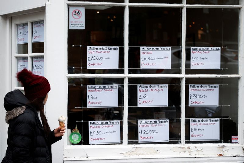 &copy; Reuters. A person looks at the adverts in the window of a job agency in London, Britain October 13, 2020. REUTERS/Hannah McKay/File photo
