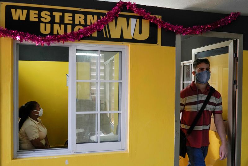 &copy; Reuters. FILE PHOTO: A client leaves a Western Union office in Havana, Cuba, November 23, 2020.  REUTERS/Alexandre Meneghini/File Photo