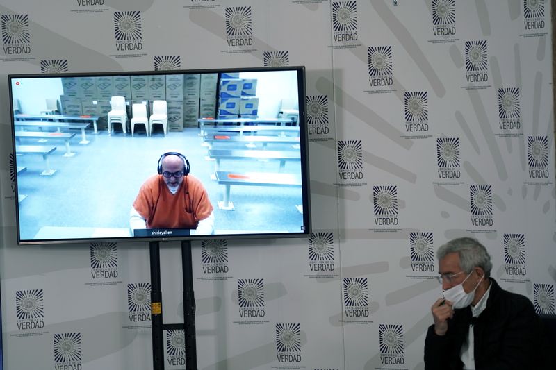 &copy; Reuters. FILE PHOTO: Former paramilitary leader Salvatore Mancuso gives testimony though live video screen to the country's truth commission as Francisco de Roux, President of the Truth Commission looks on in Bogota, Colombia, August 4, 2021. REUTERS/Nathalia Anga