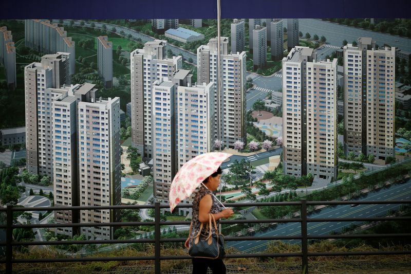 &copy; Reuters. A woman walks past an advertisement promoting an apartment complex in Yongin, South Korea, August 24, 2016. REUTERS/Kim Hong-Ji