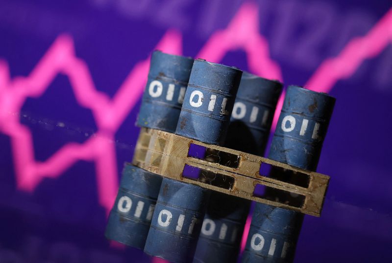&copy; Reuters. Miniature di barili di petrolio e un grafico azionario in crescita. REUTERS/Dado Ruvic