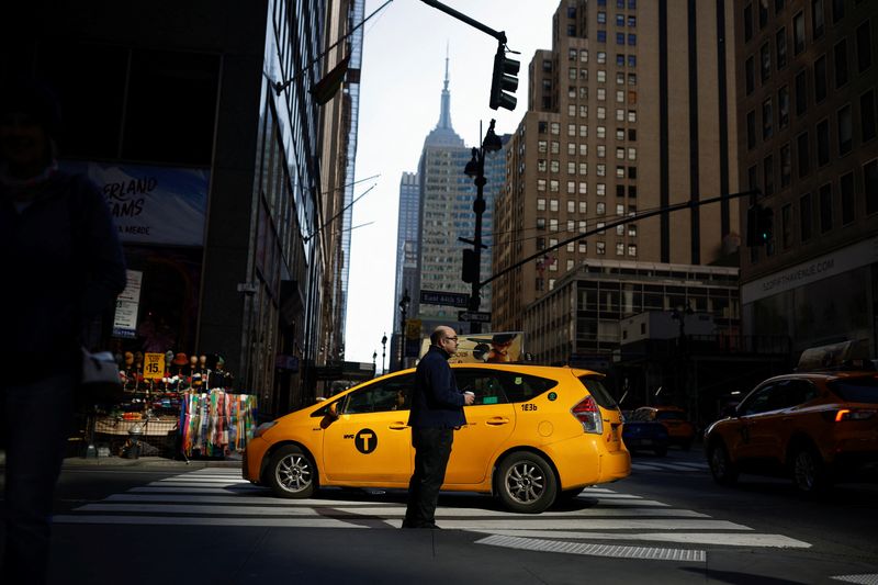 &copy; Reuters. A man stands on the street as a taxi passes in Manhattan, in New York City, U.S., March 20, 2023. REUTERS/Amanda Perobelli/File Photo